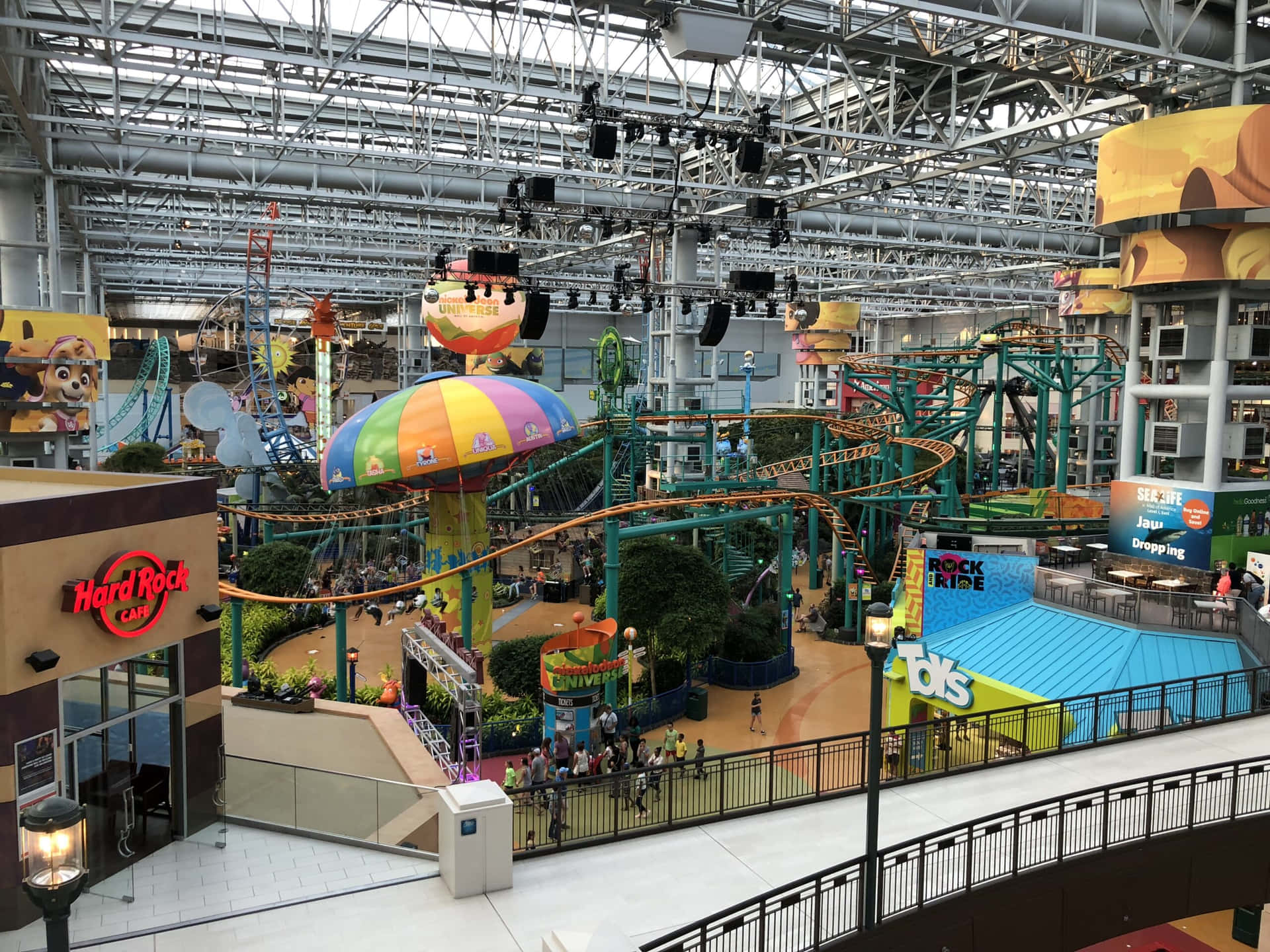 A Mall With A Roller Coaster And Other Rides