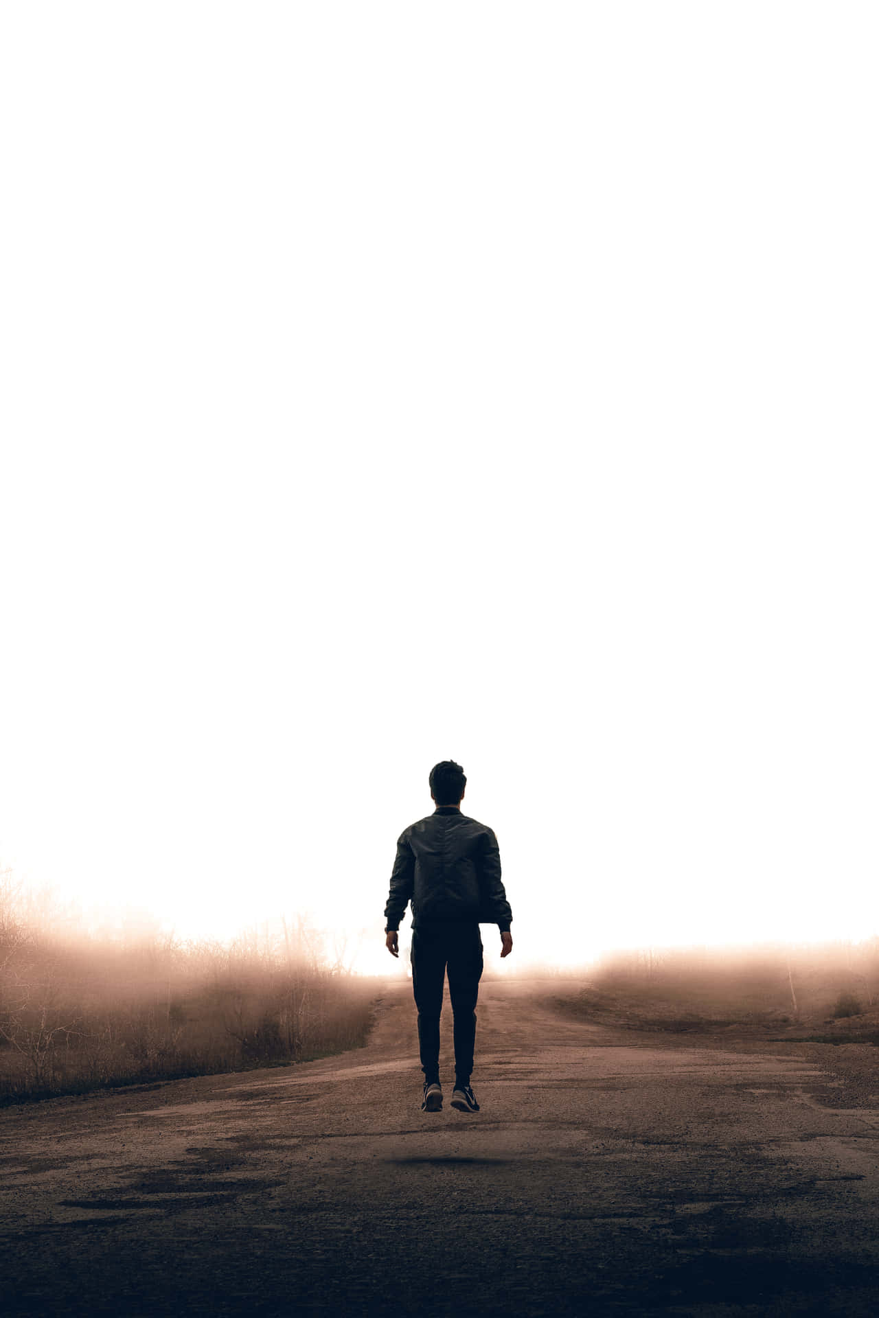 A Man Walking Down A Road