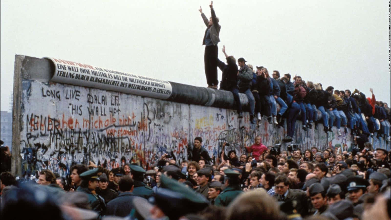Man Celebrating The Fall Of The Berlin Wall Wallpaper