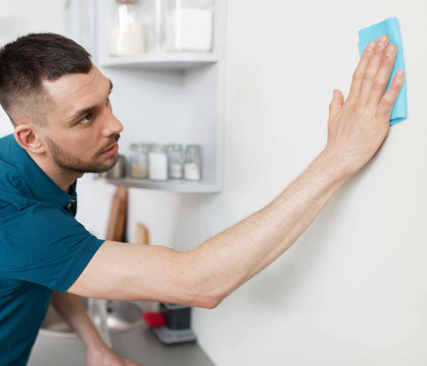 Man Cleaning White Wall Wallpaper