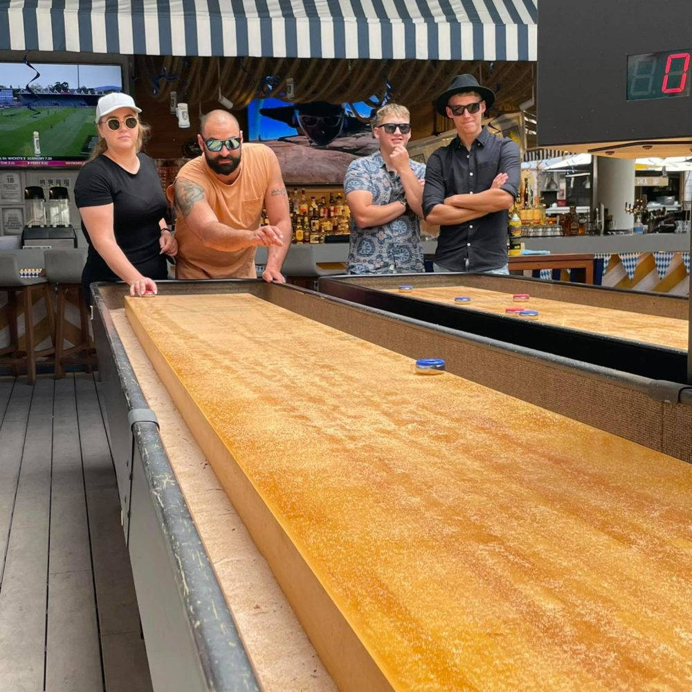 Thrilling Competition on Shuffleboard Table Wallpaper