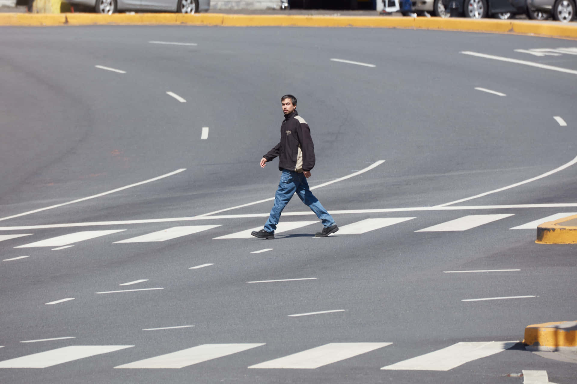 Man Crossing Empty Urban Intersection Wallpaper