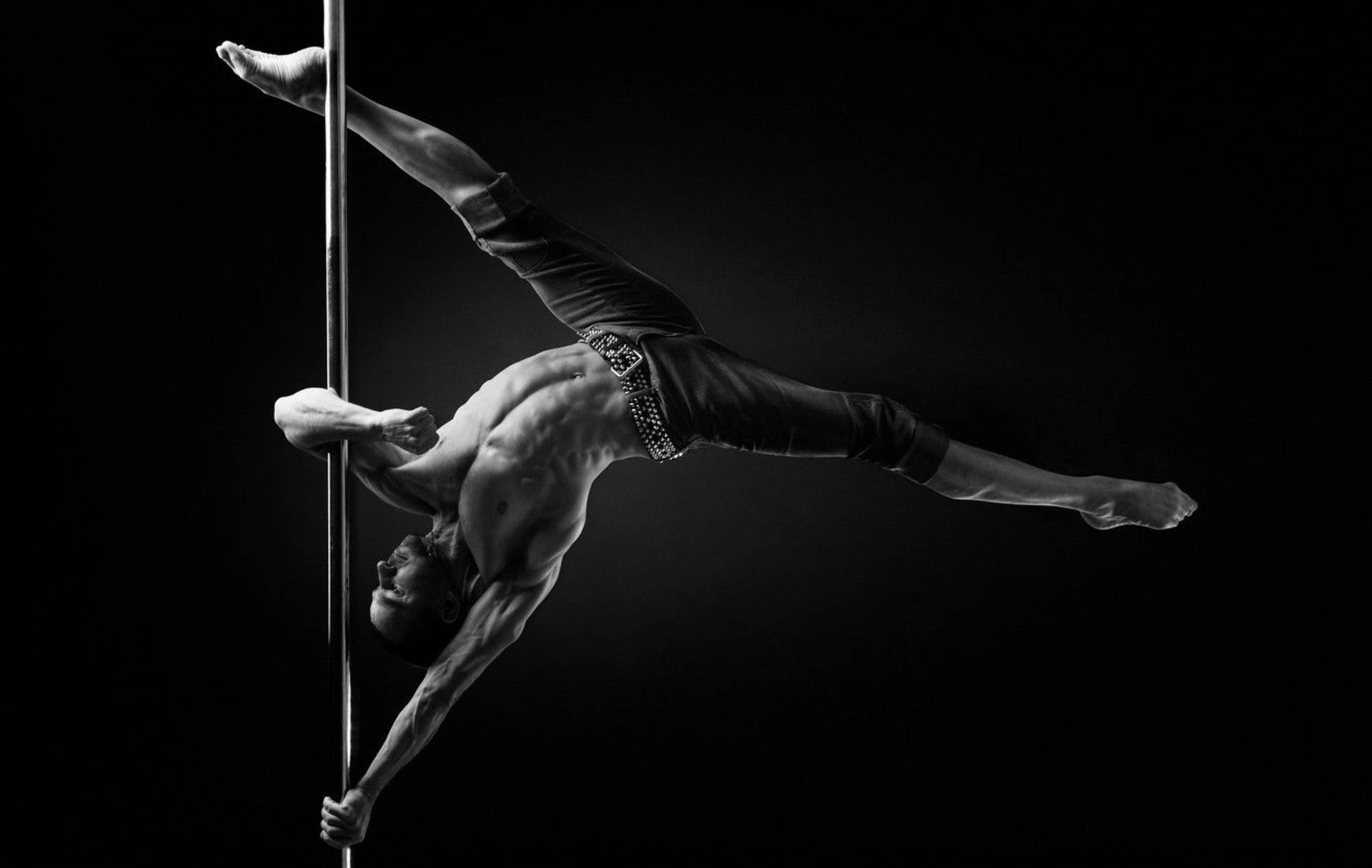 Captivating Pole Dancer Demonstration Wallpaper