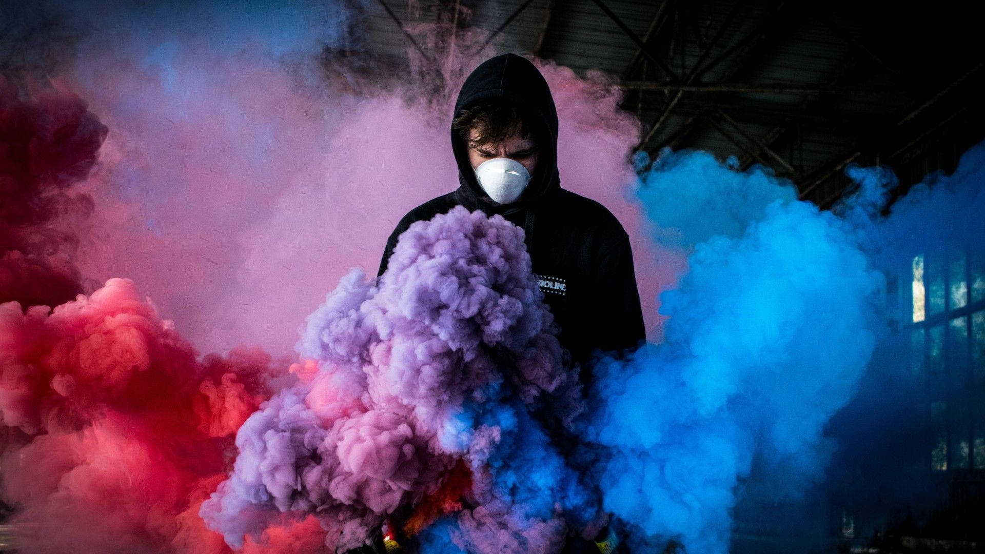 Man Engulfed With Colorful Gas Smoke Wallpaper