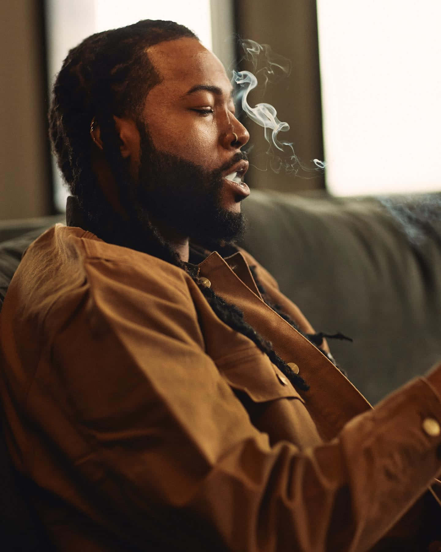 Man Exhaling Smoke Portrait Wallpaper