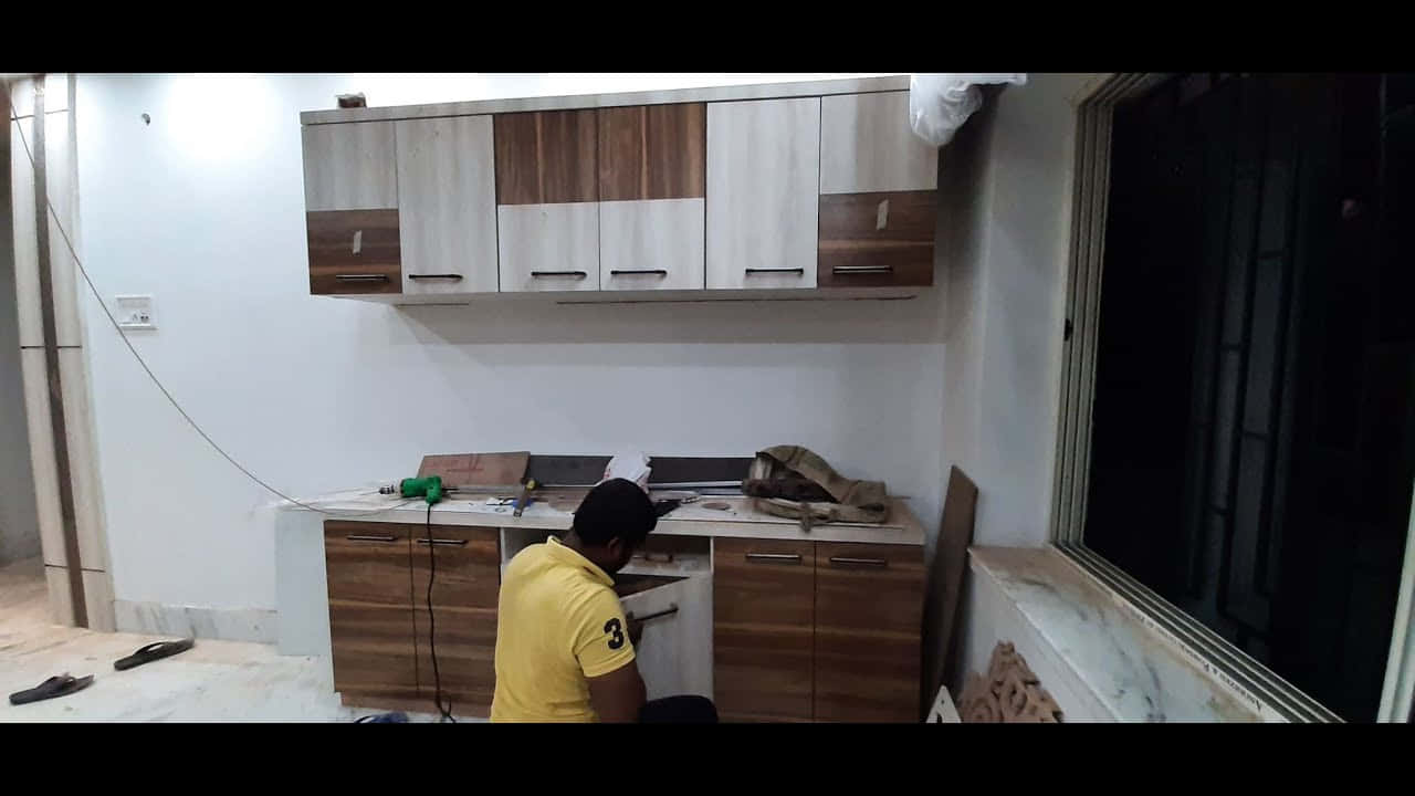 Man Fixing Modular Kitchen Picture