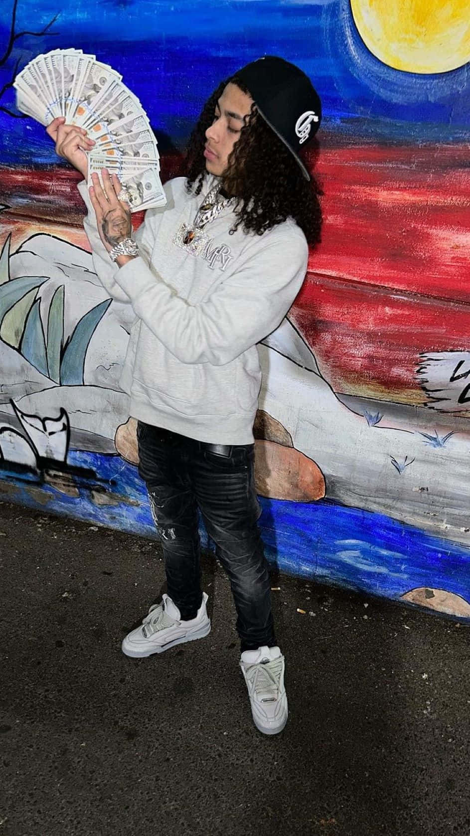 Man Flaunting Money Against Graffiti Wall Wallpaper