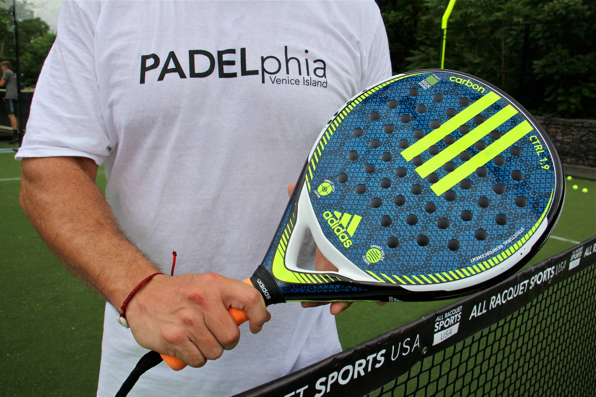 Man Holding Adidas Racquetball Racket Wallpaper
