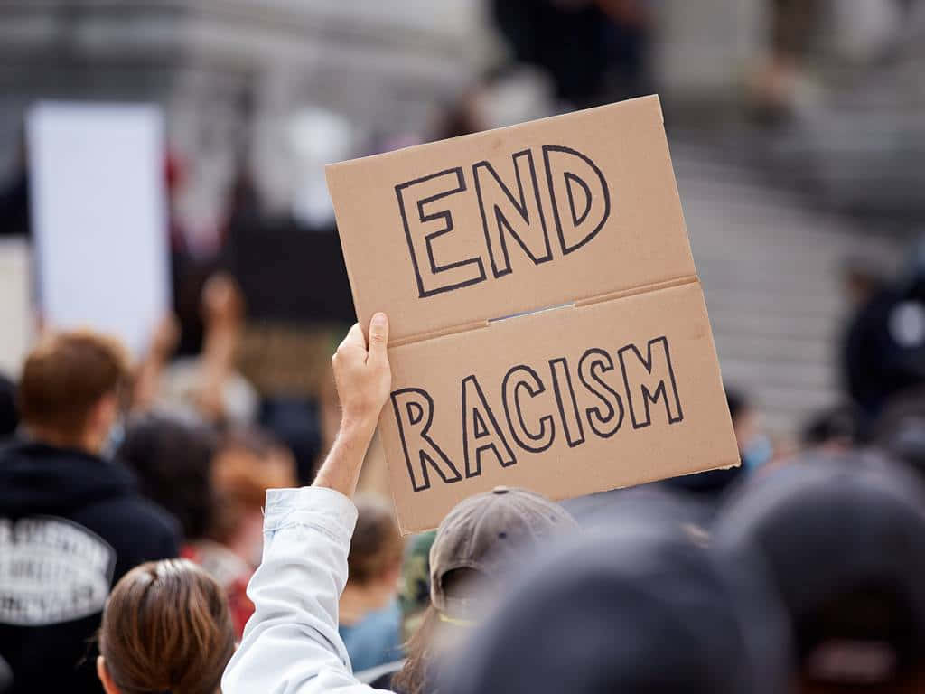 Man Holding An End Racism Sign Wallpaper