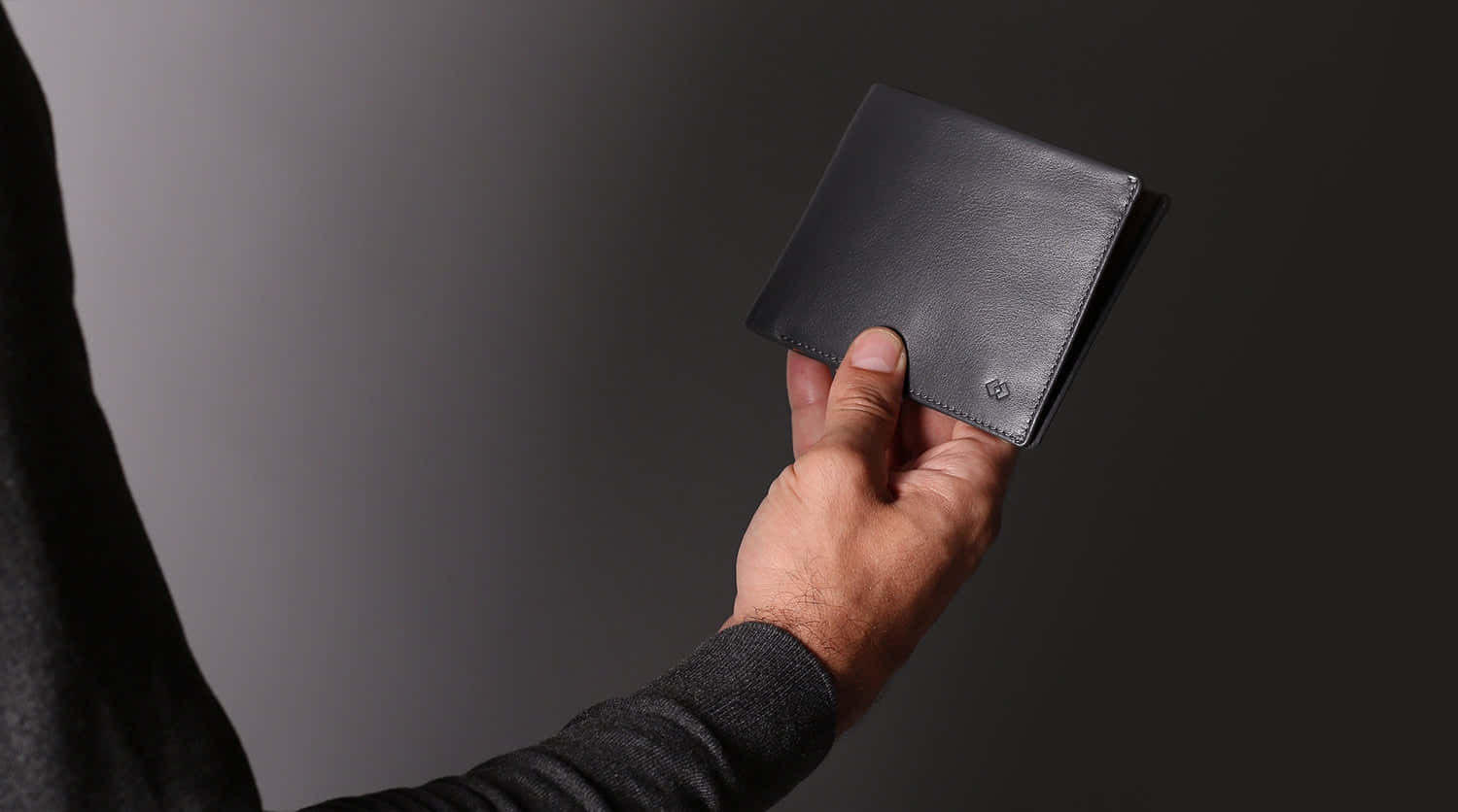 Man Holding Black Leather Wallet Wallpaper