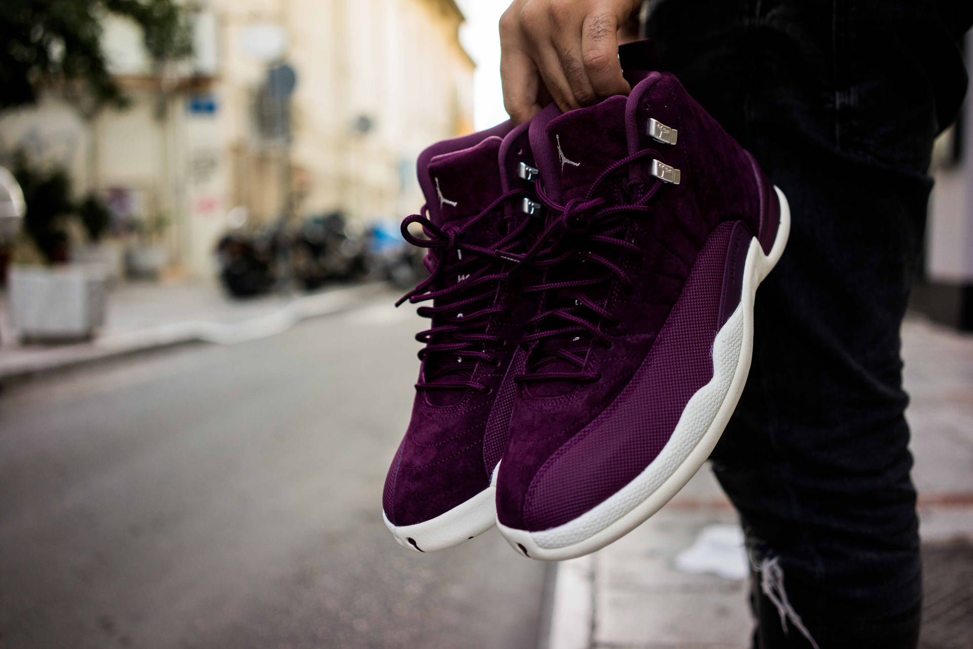 Man Holding Purple Sneakers
