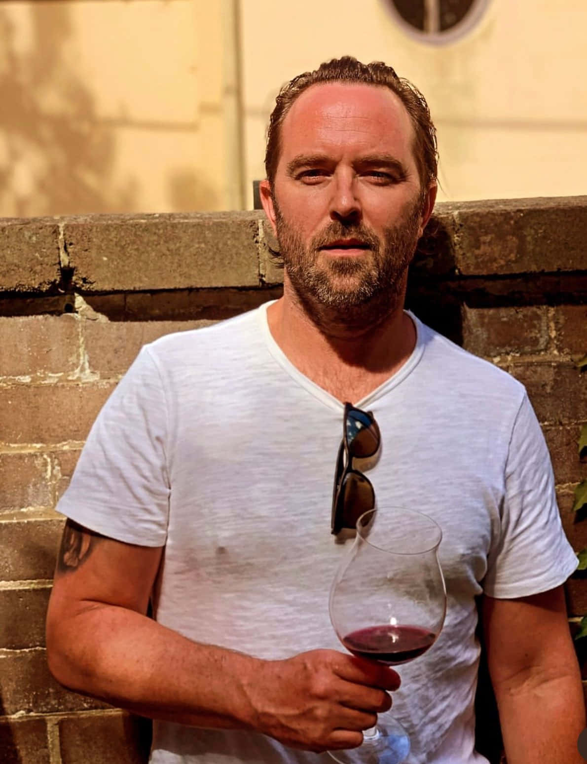 Man Holding Wine Glass Outdoors Wallpaper