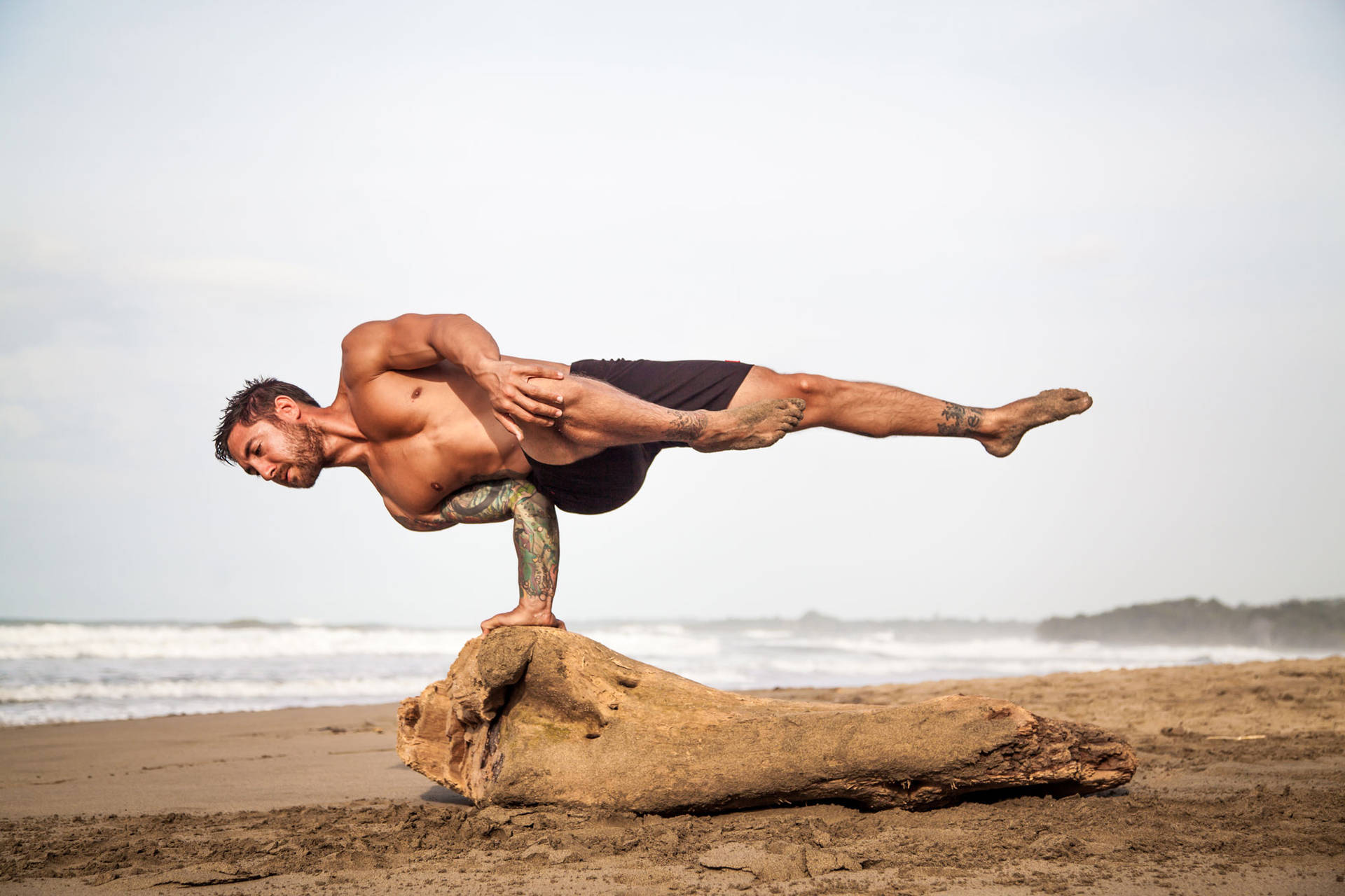 Man In Extreme Yoga Stance Wallpaper