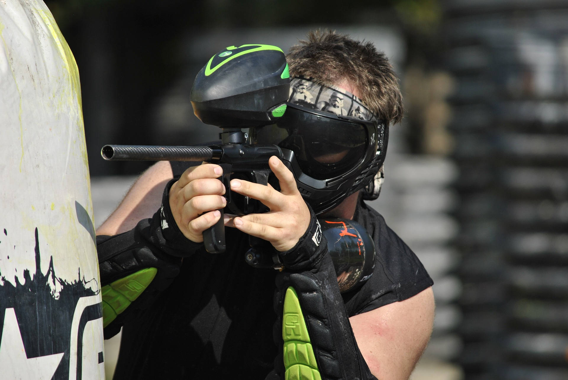 Man In Green Elbow Pads Shooting Paintball Wallpaper