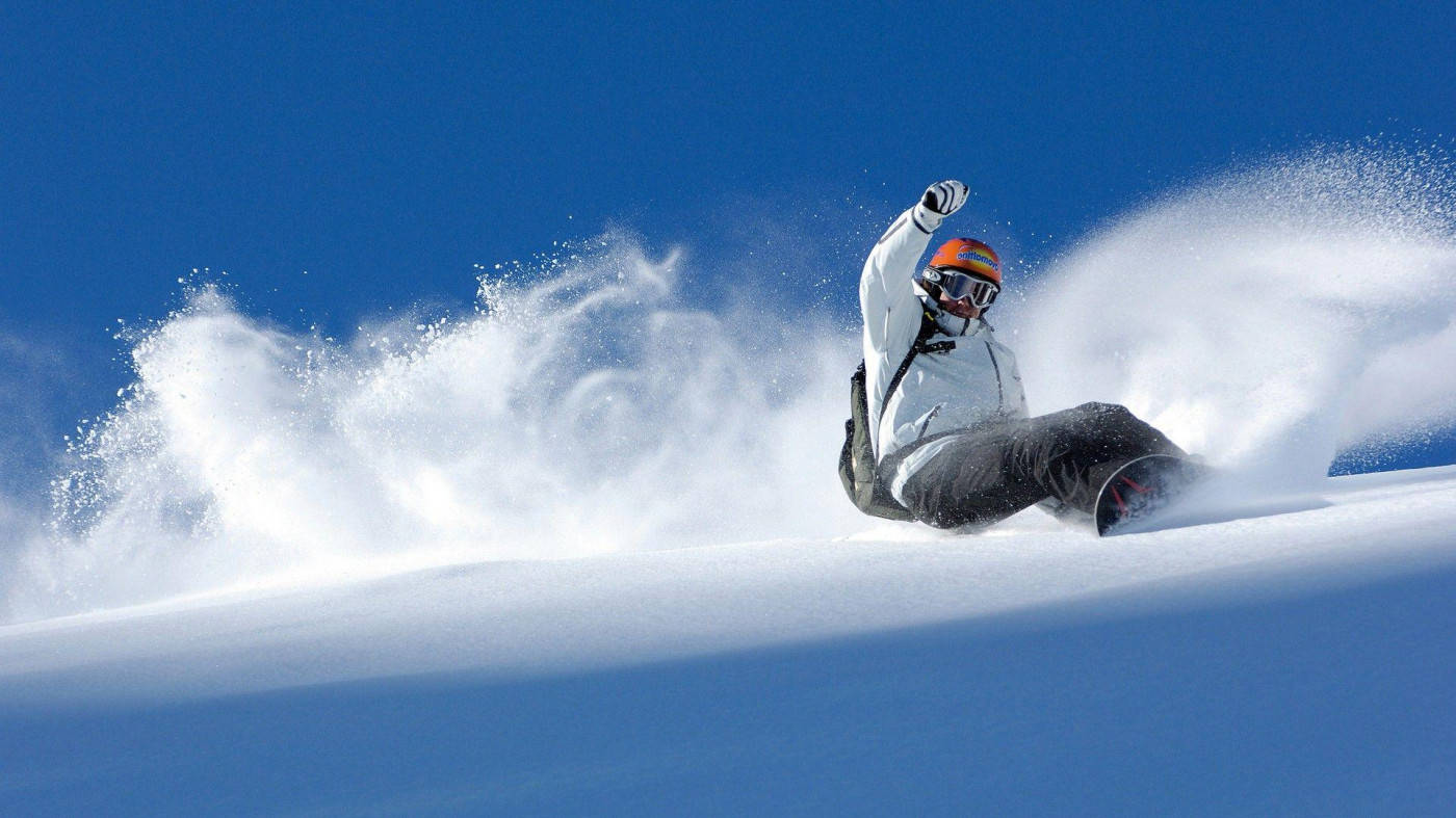 Man In Orange And White With Snowboard Wallpaper