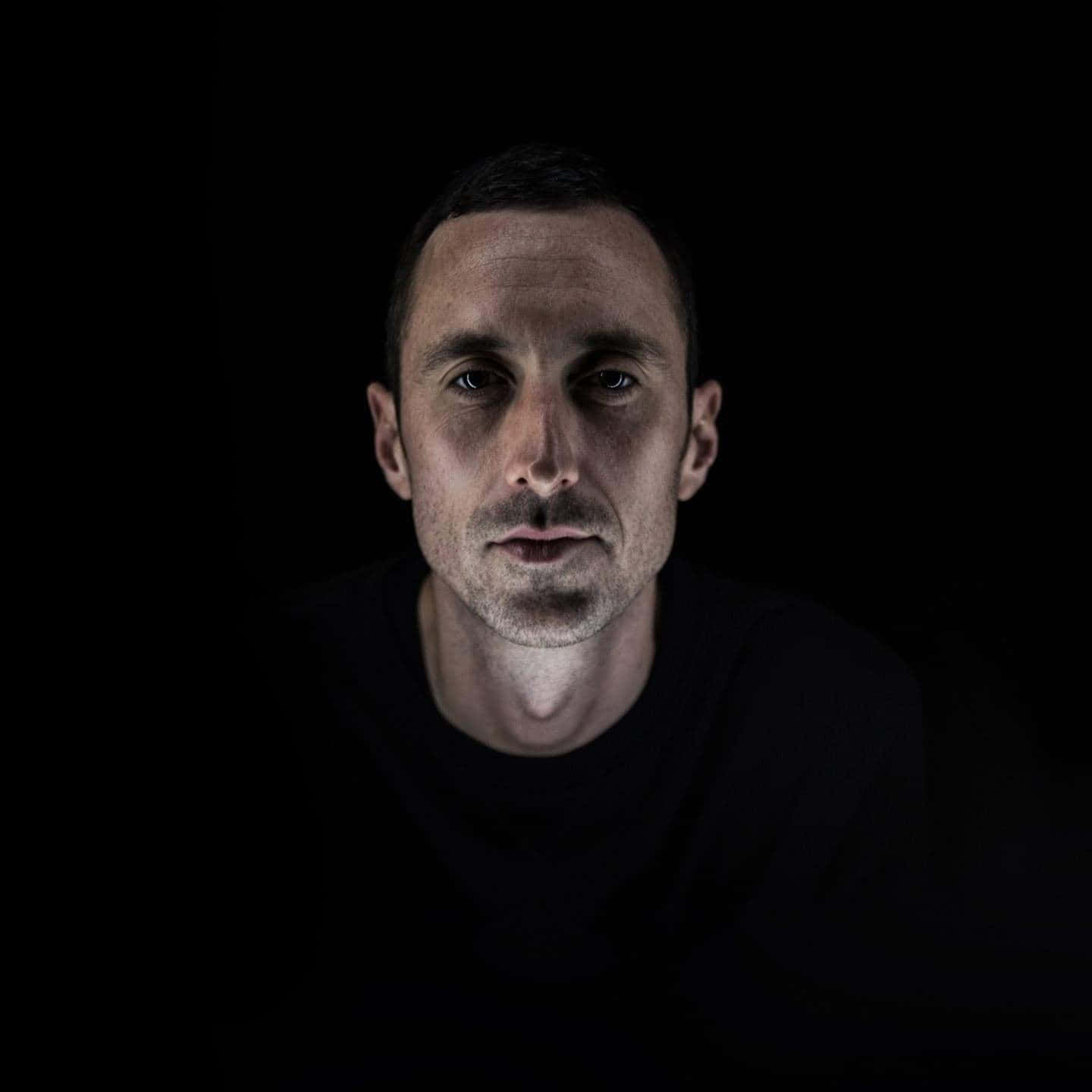 Man In Shadowed Contemplation.jpg Wallpaper