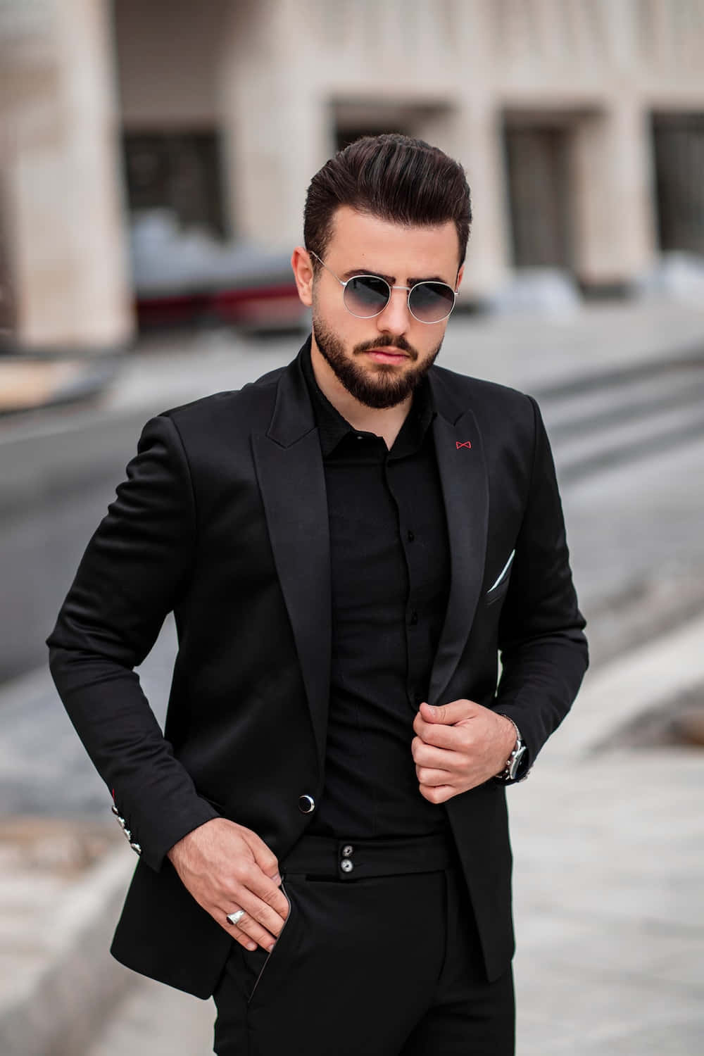A Man In A Black Suit And Sunglasses