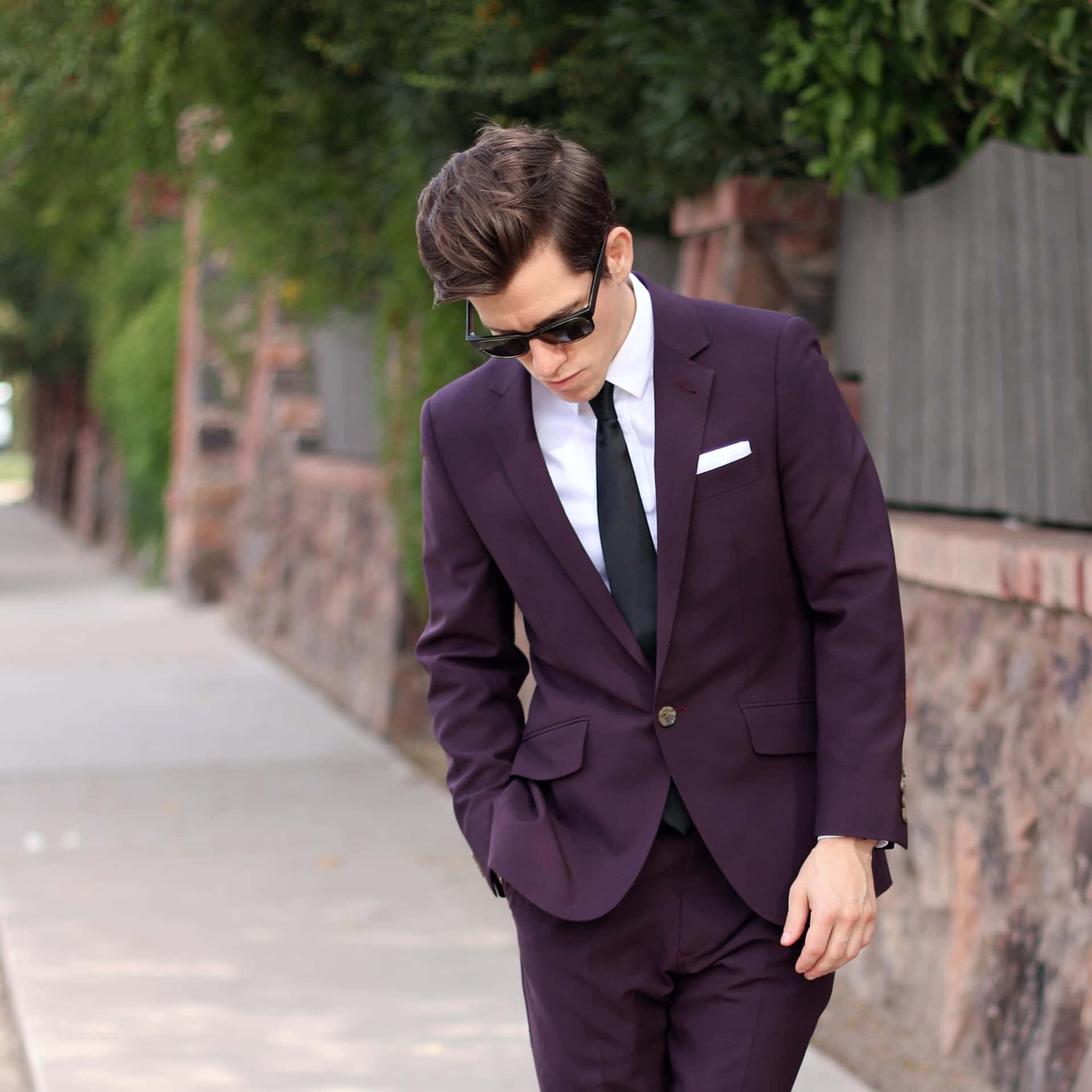 A Man In A Purple Suit Walking Down The Sidewalk