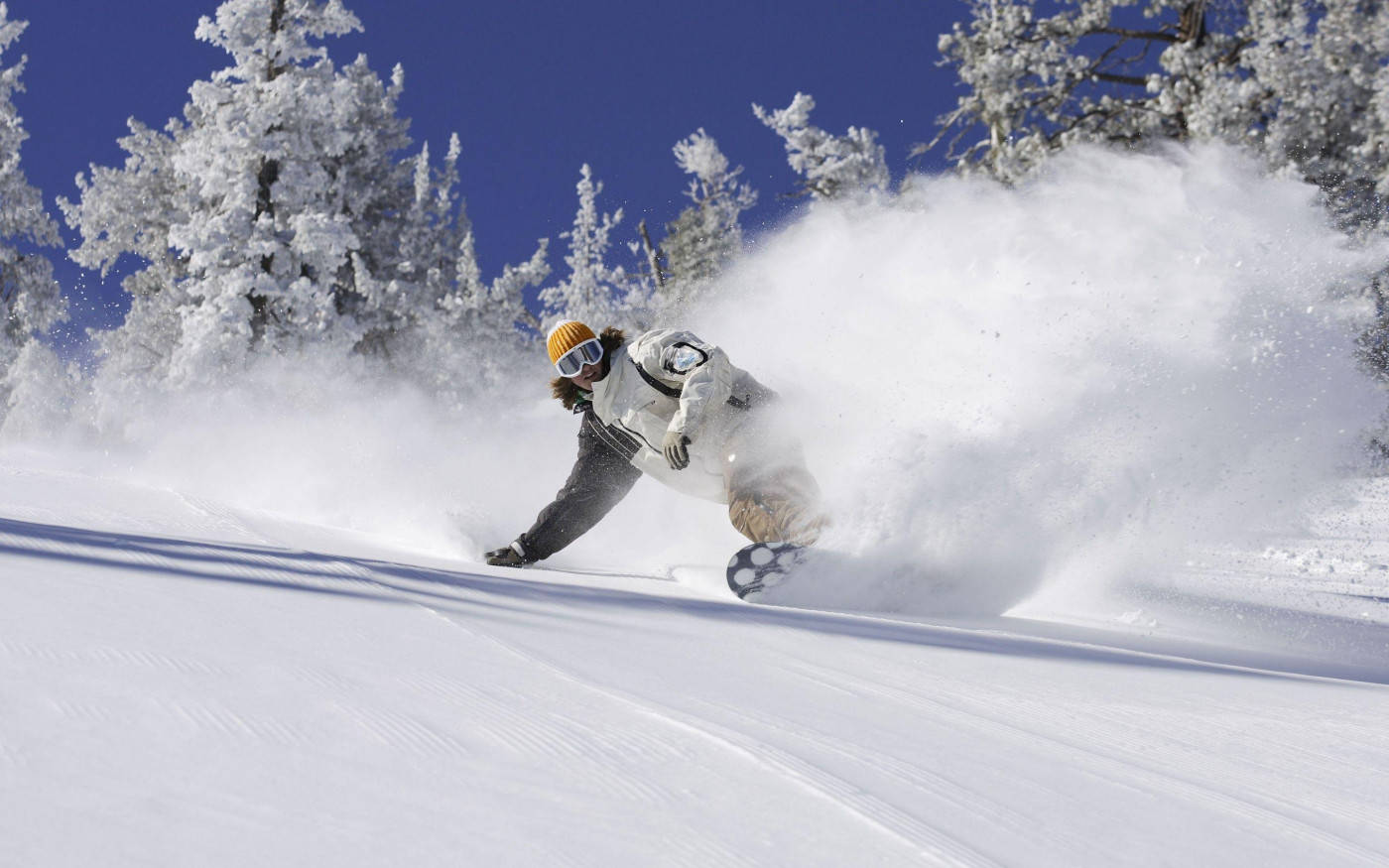 Man In White Descending With Snowboard Background