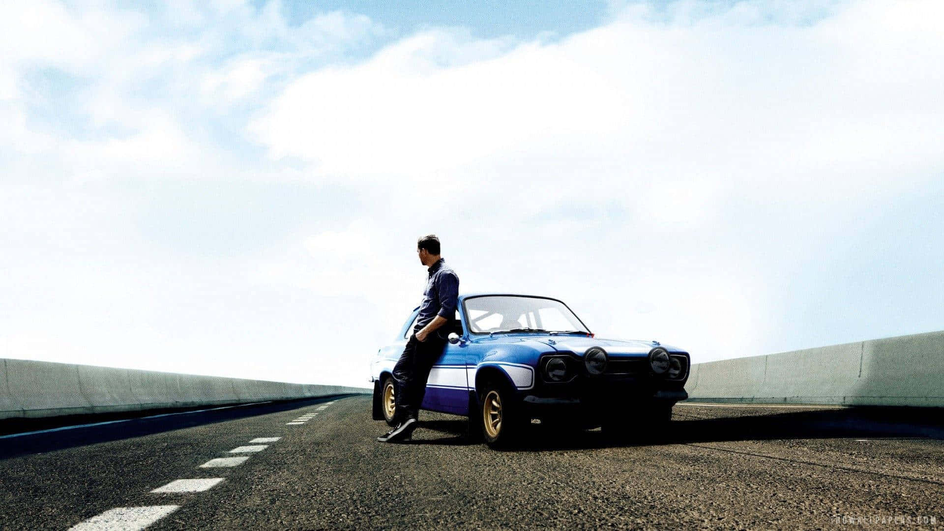 Man Leaningon Classic Caron Open Road Wallpaper