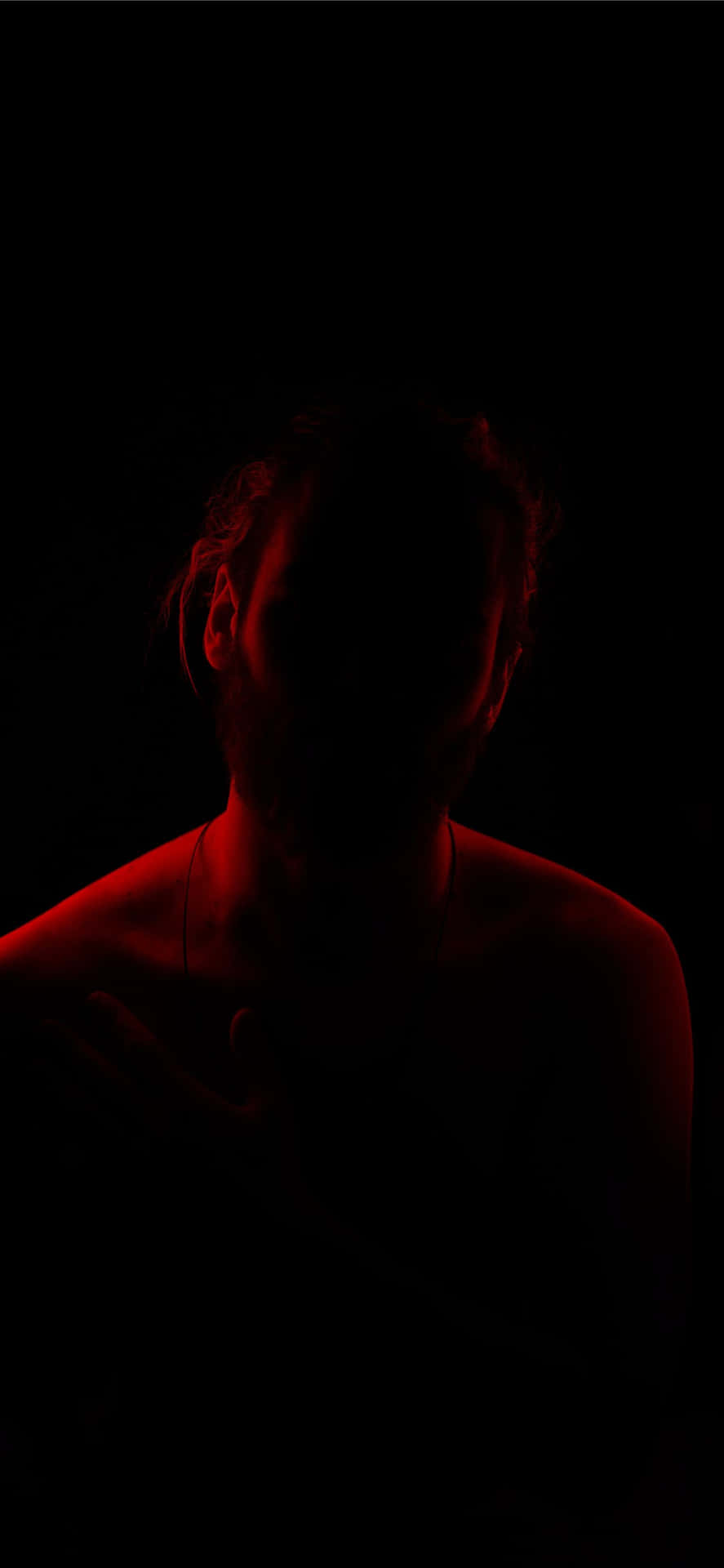 Man On A Somber Night With Red Light Wallpaper