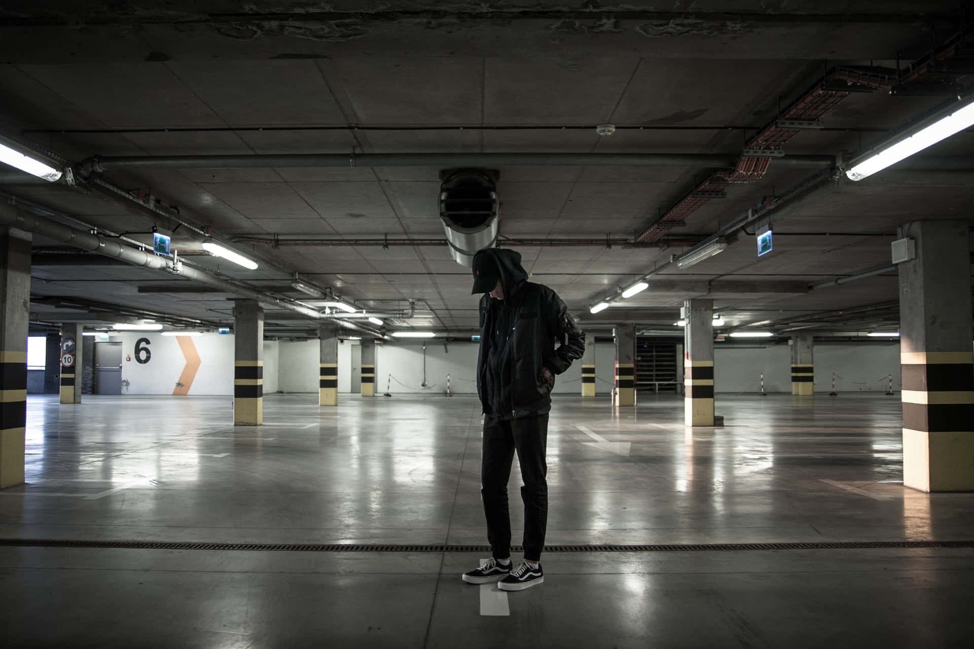Lone Man in an Underground Parking Lot Wallpaper
