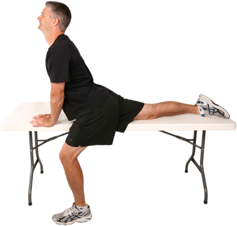 Man Performing Hip Flexor Stretchon Table PNG
