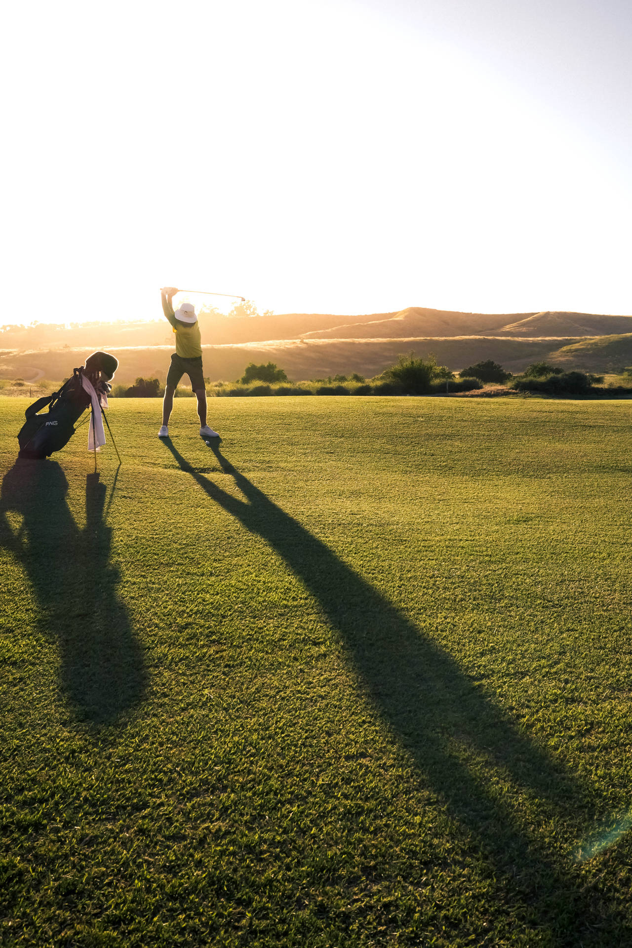 Man Playing On Golf Course During Sunset