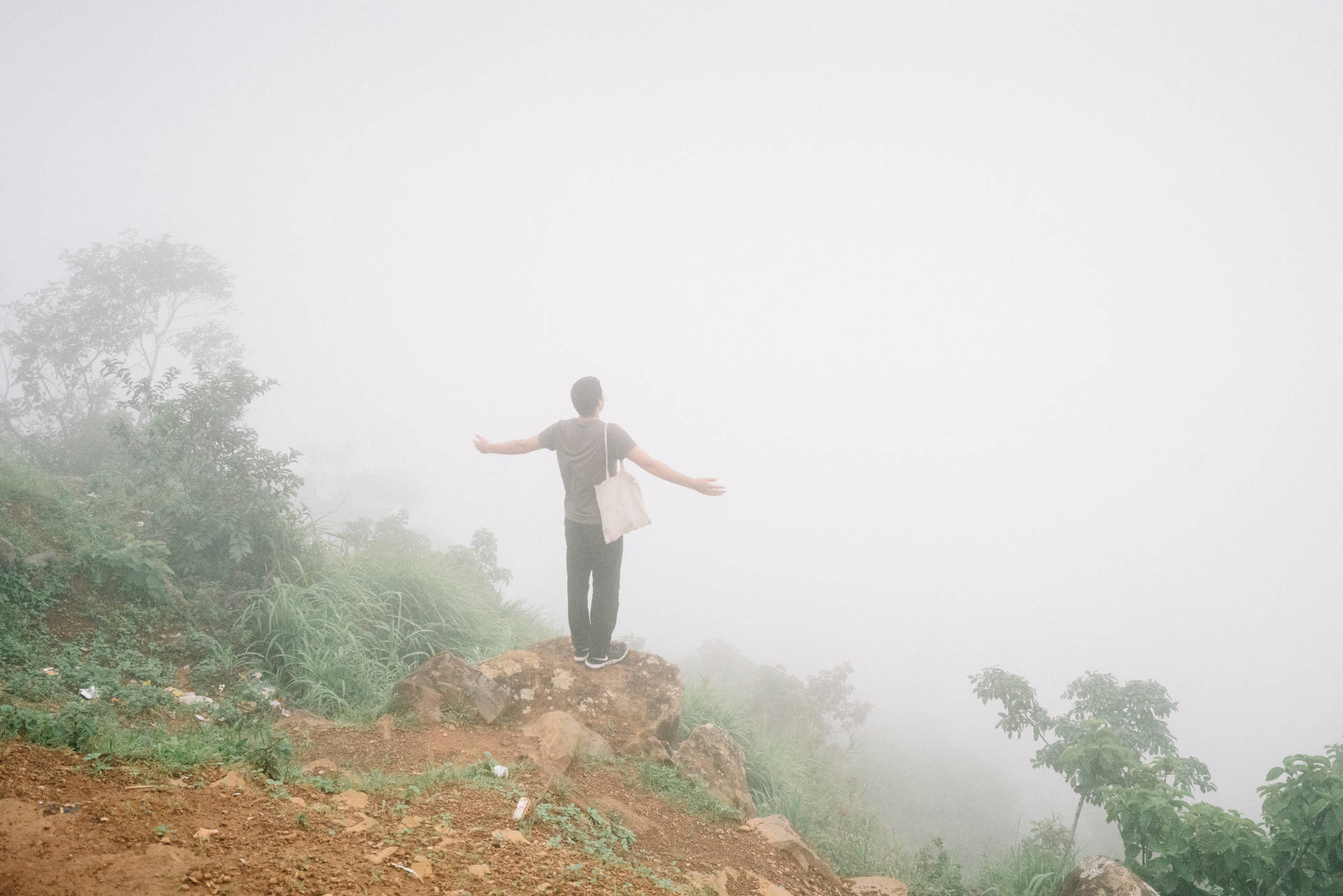 Man Posing At Cliff Edge In Sierra Leone Wallpaper