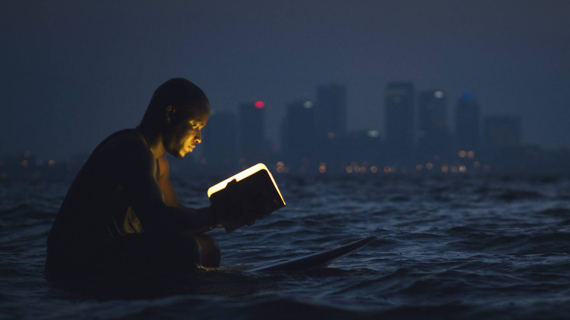 Man Reading Book In Ocean Wallpaper