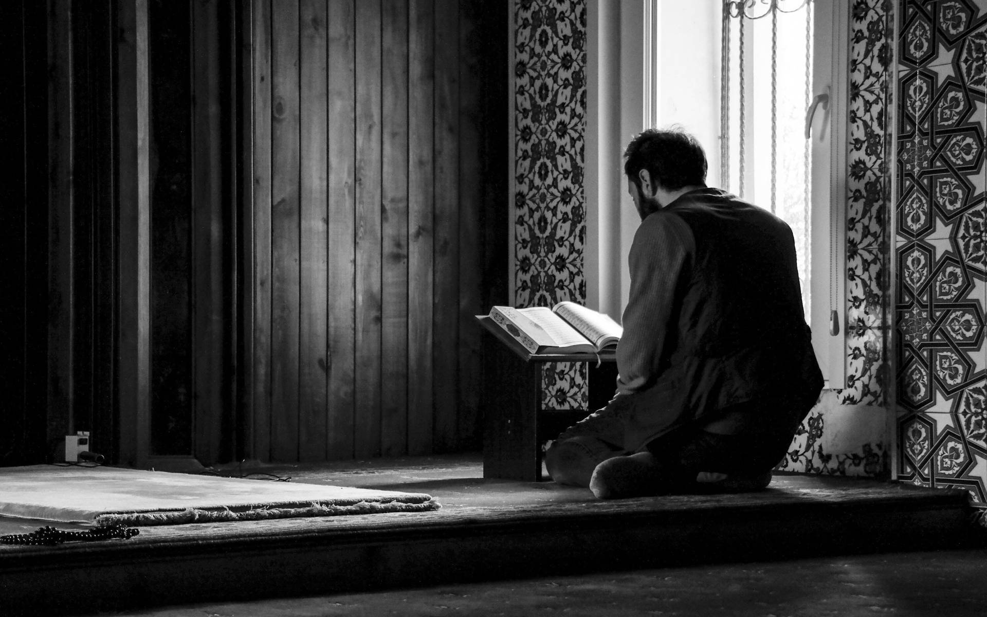 Man Reading Quran Grayscale Wallpaper