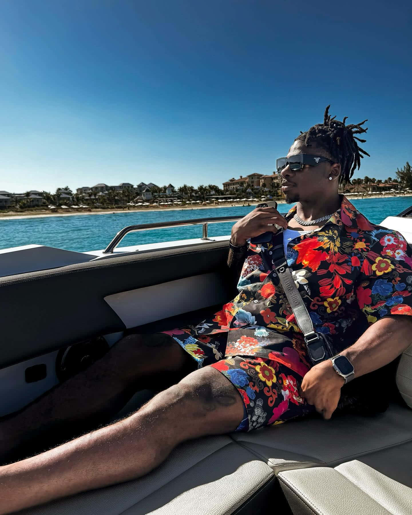 Man Relaxingon Boatin Floral Outfit Wallpaper