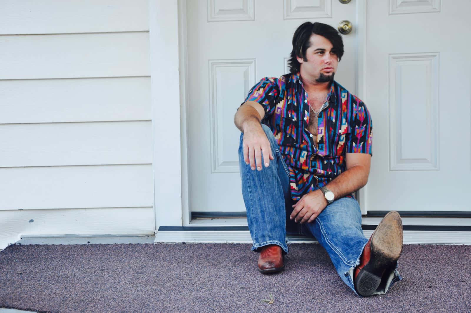 Man Seated By Doorway Wallpaper