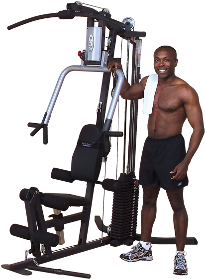 Man Smiling Beside Multi Gym Equipment PNG