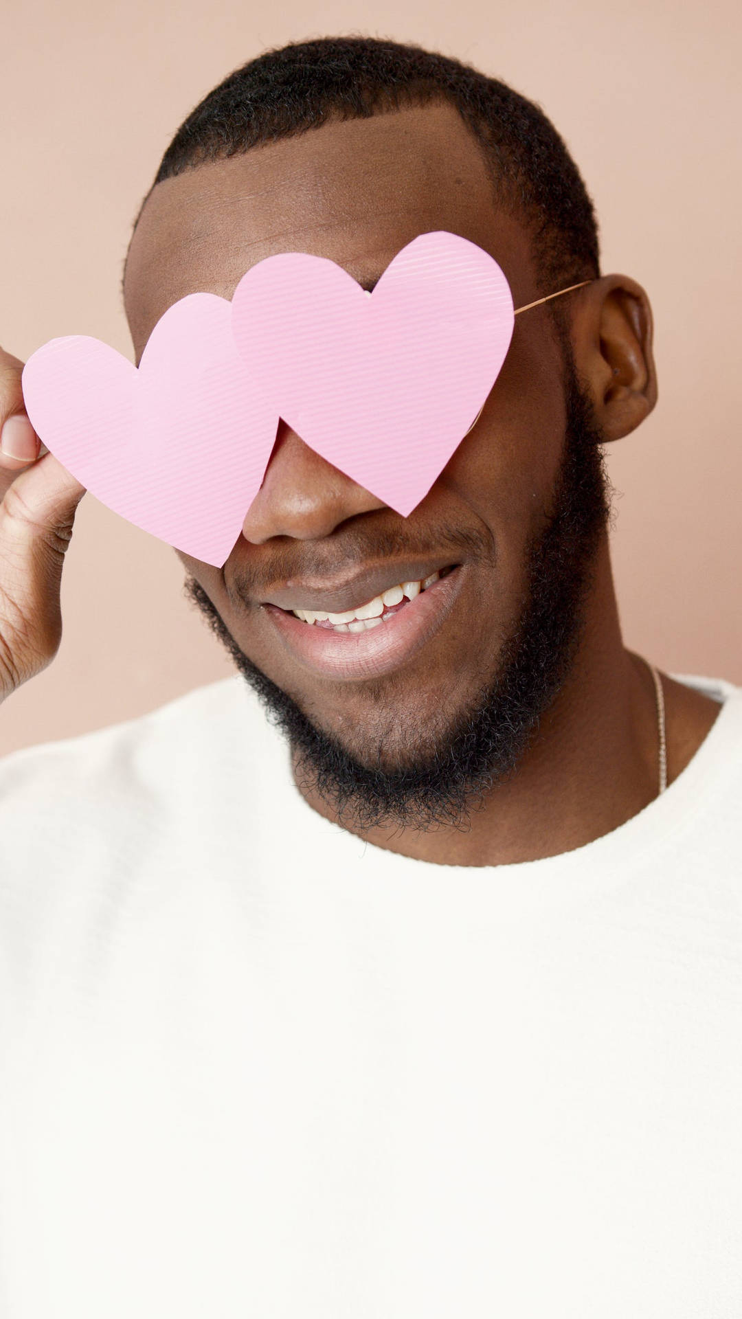 Man Smiling With Pastel Pink Heart Wallpaper