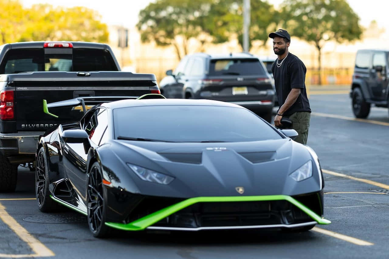Man Standing Beside Black Lamborghini Huracan Wallpaper