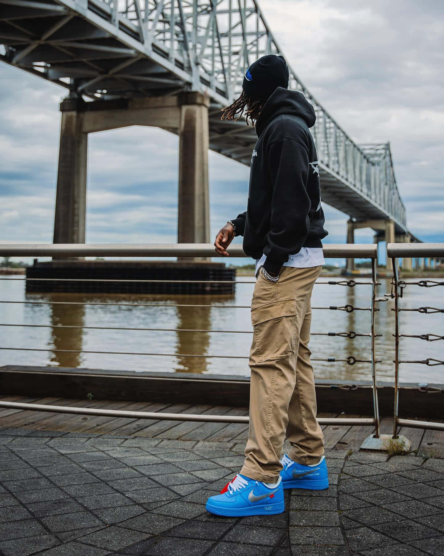 Man Standing Near Bridge Waterfront Wallpaper