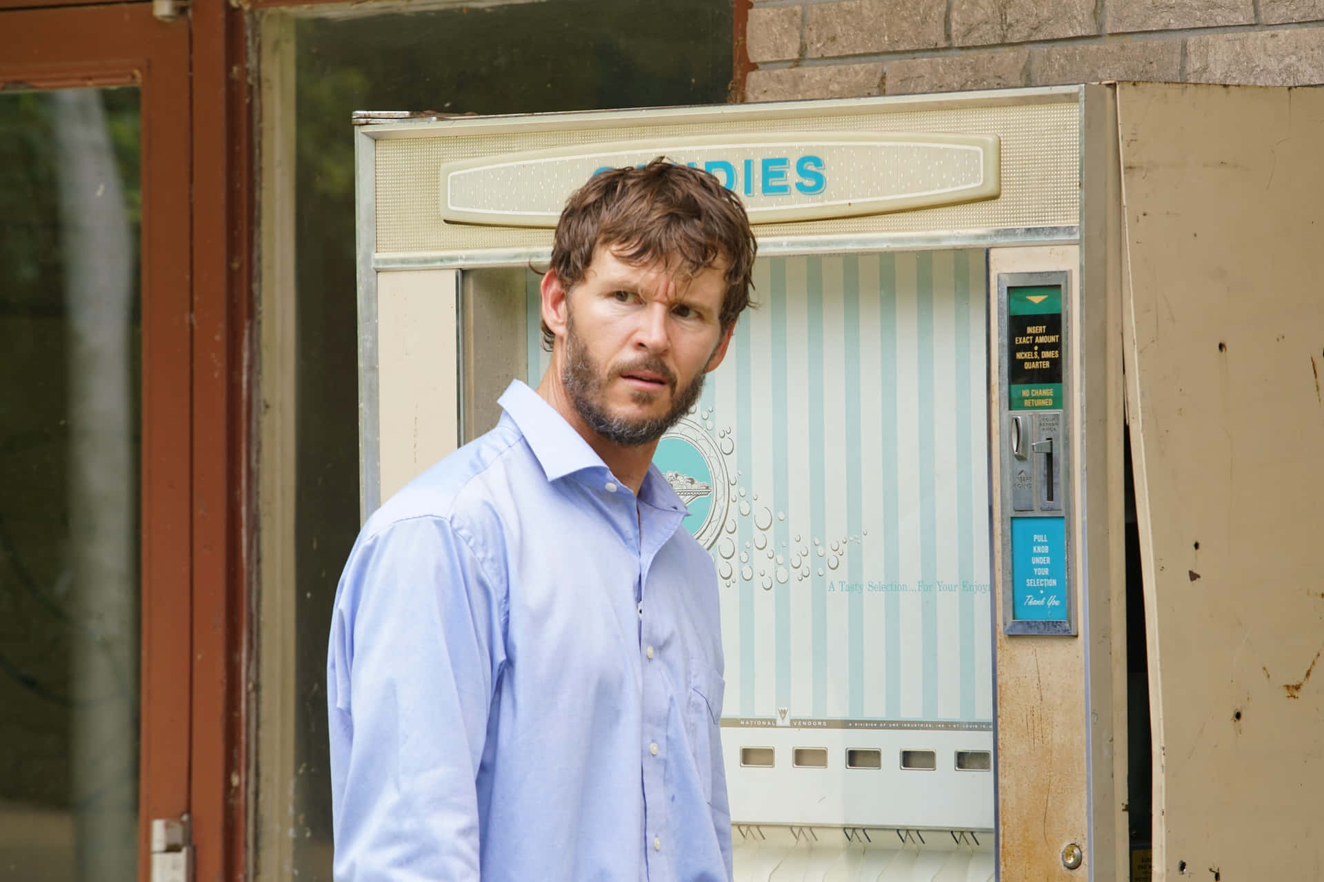 Man Standing Near Tanning Salon Wallpaper