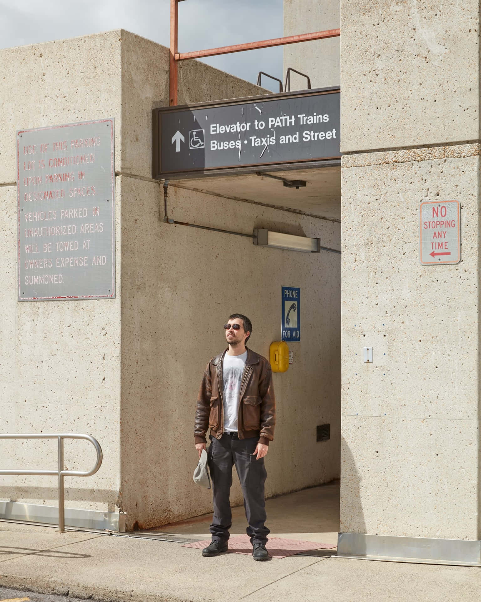 Man Standing Near Transportation Signs Wallpaper