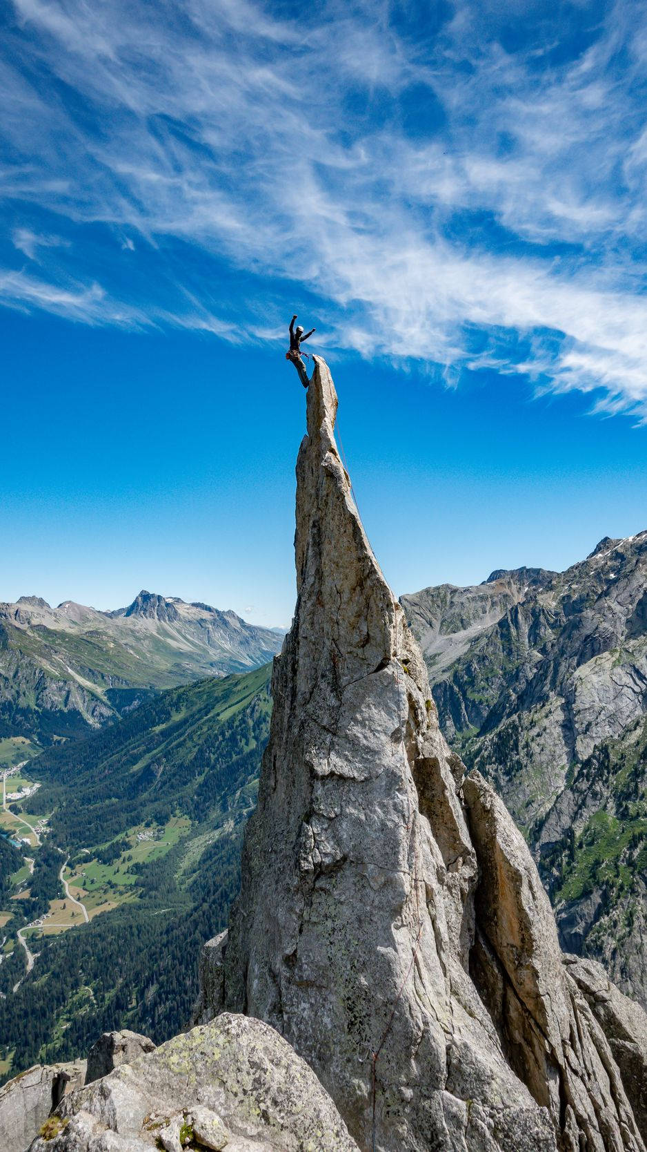 Man Succeeds In Climbing A Rock Structure Wallpaper