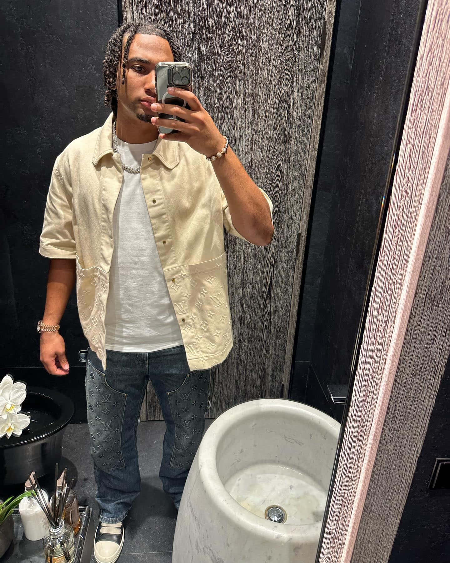 Man Taking Mirror Selfiein Bathroom Wallpaper