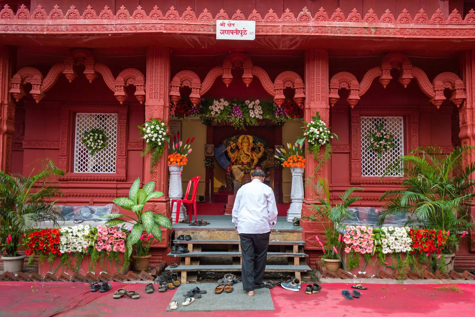 Man Visiting A Vinayaka Shrine Wallpaper