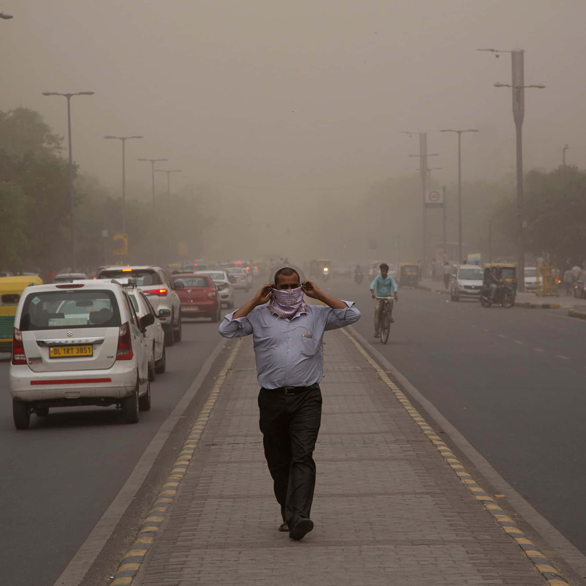 Man Walkingin Dust Storm Wallpaper
