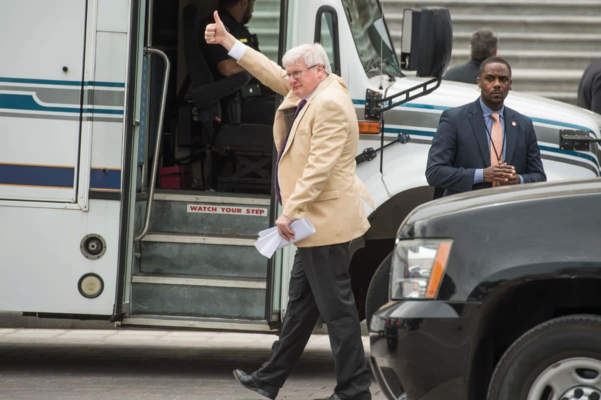 Man Waving Exiting Bus Wallpaper