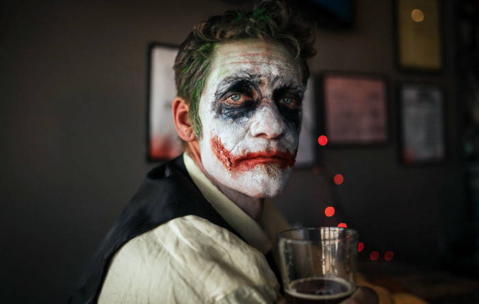 Man With Drink And Sad Joker Makeup Wallpaper