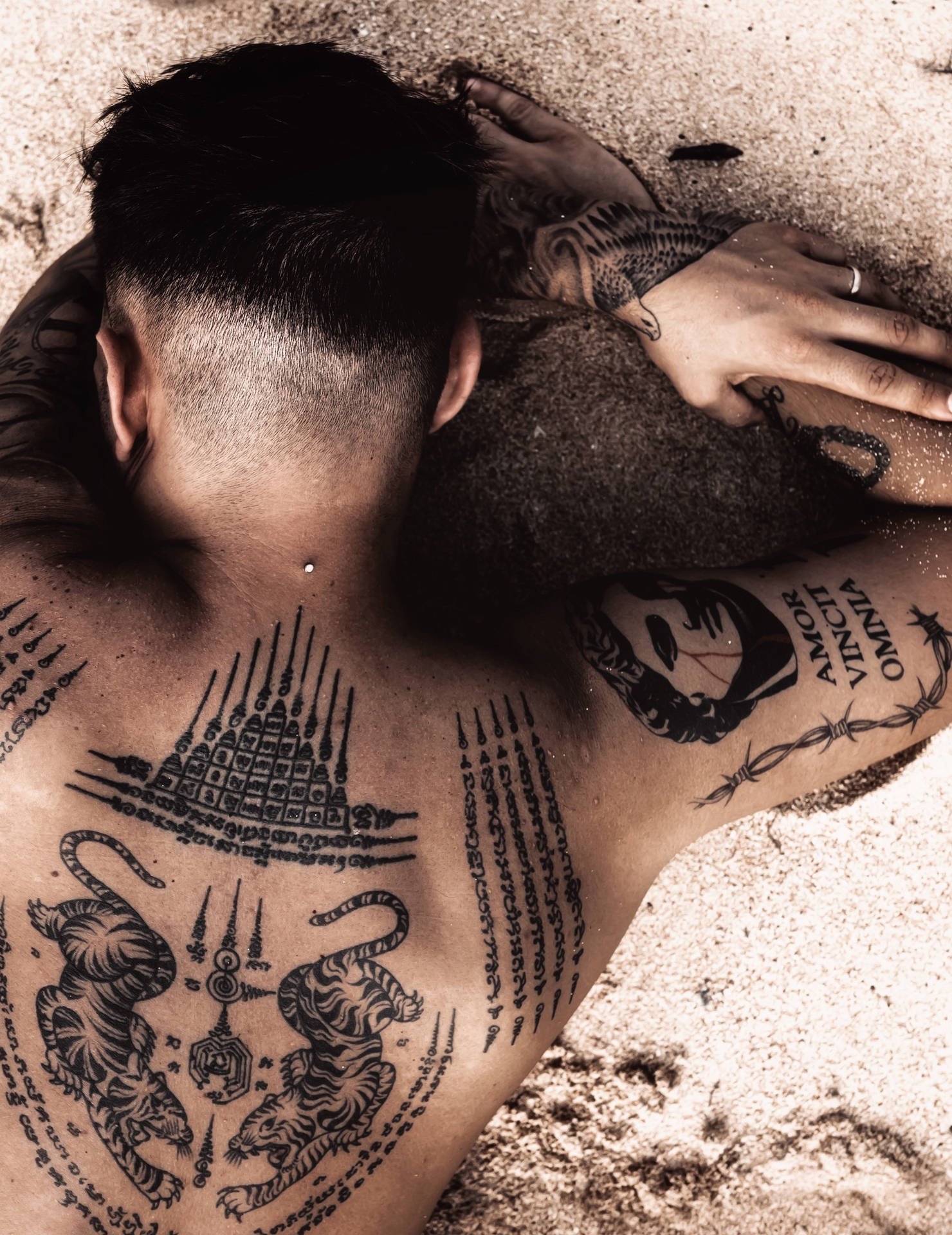 Download Man With Hd Tattoo On Sand Wallpaper 