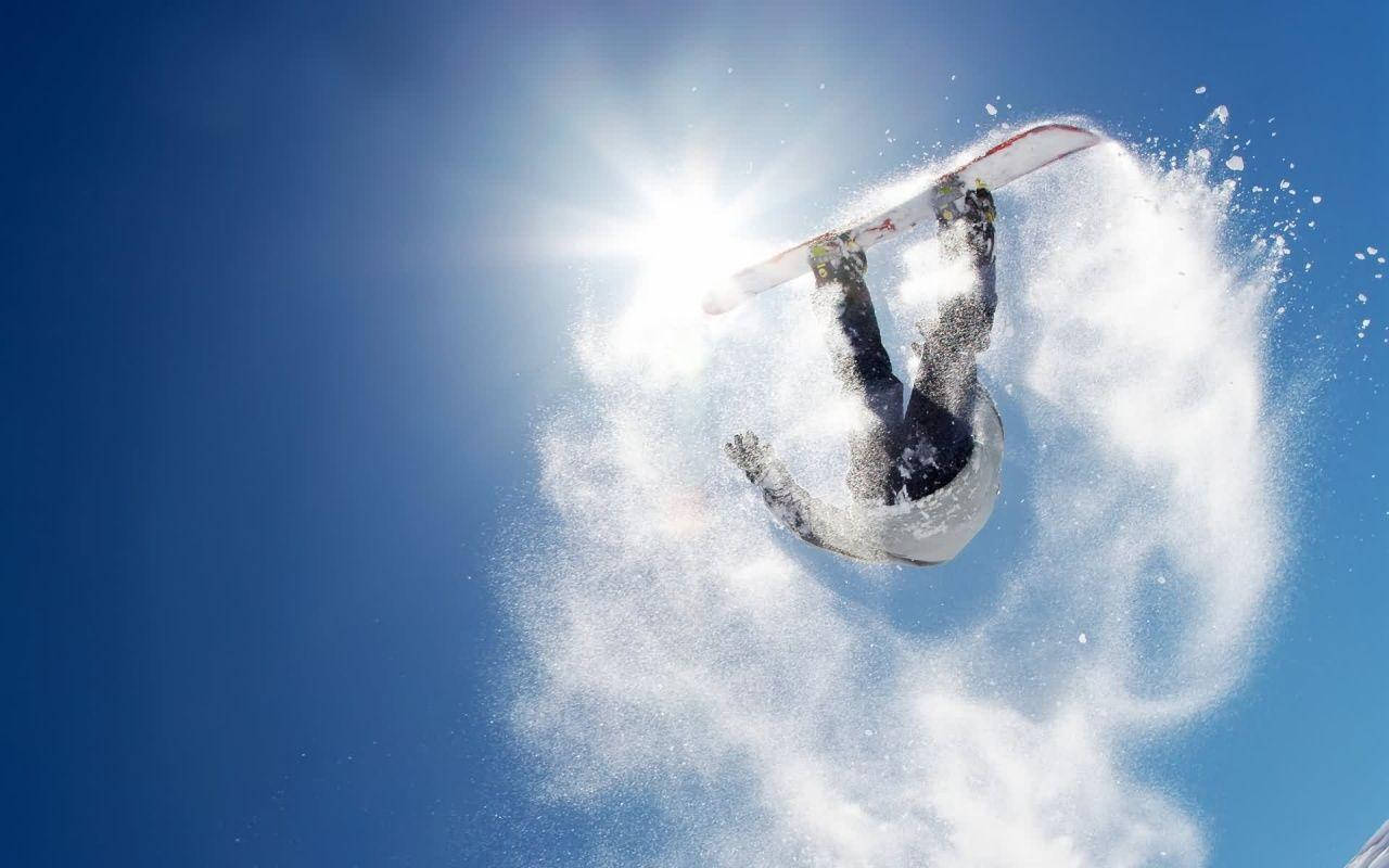 Man With Snowboard Performing A Trick Background
