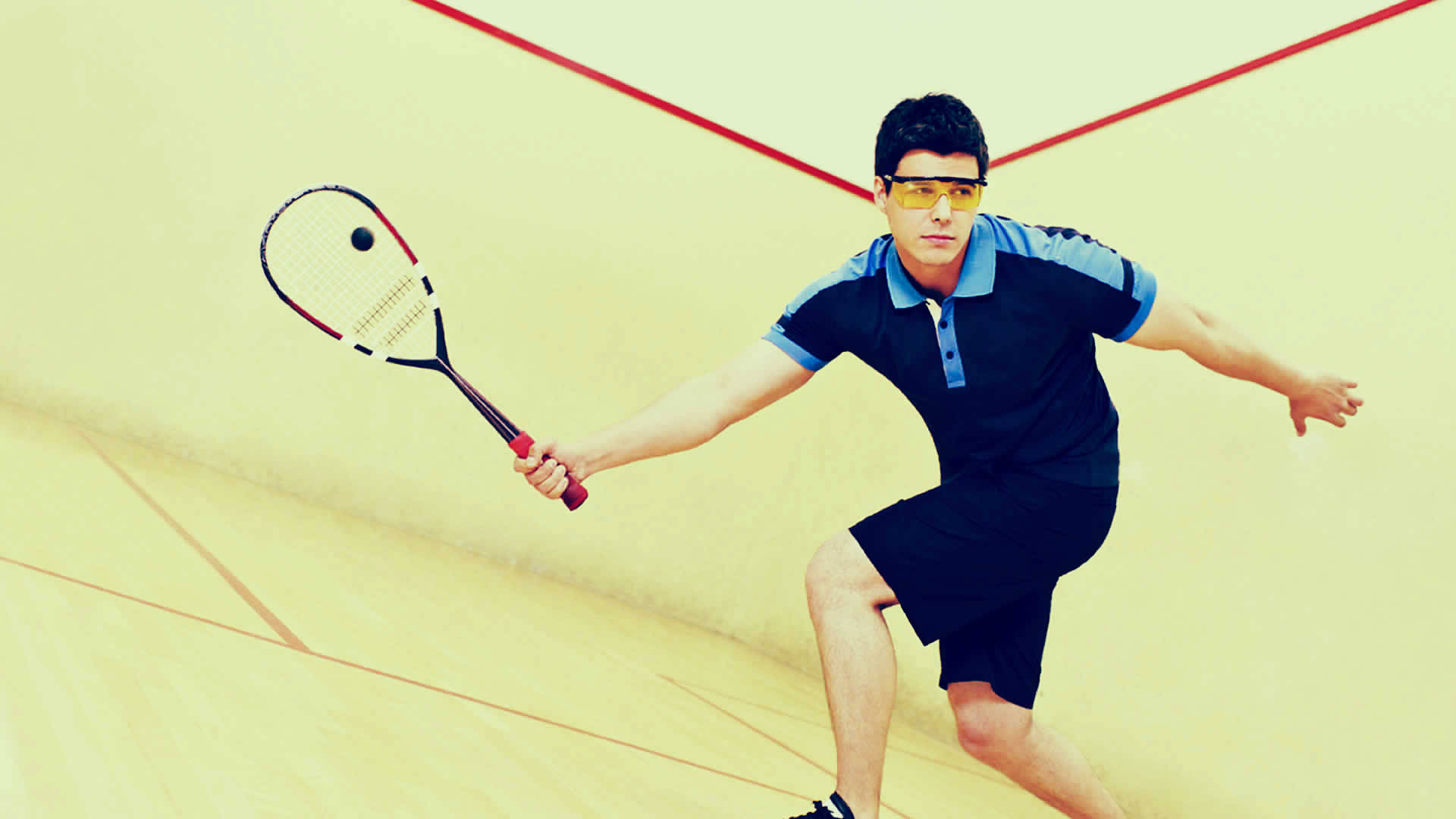 Man With Yellow Goggles Playing Squash Background