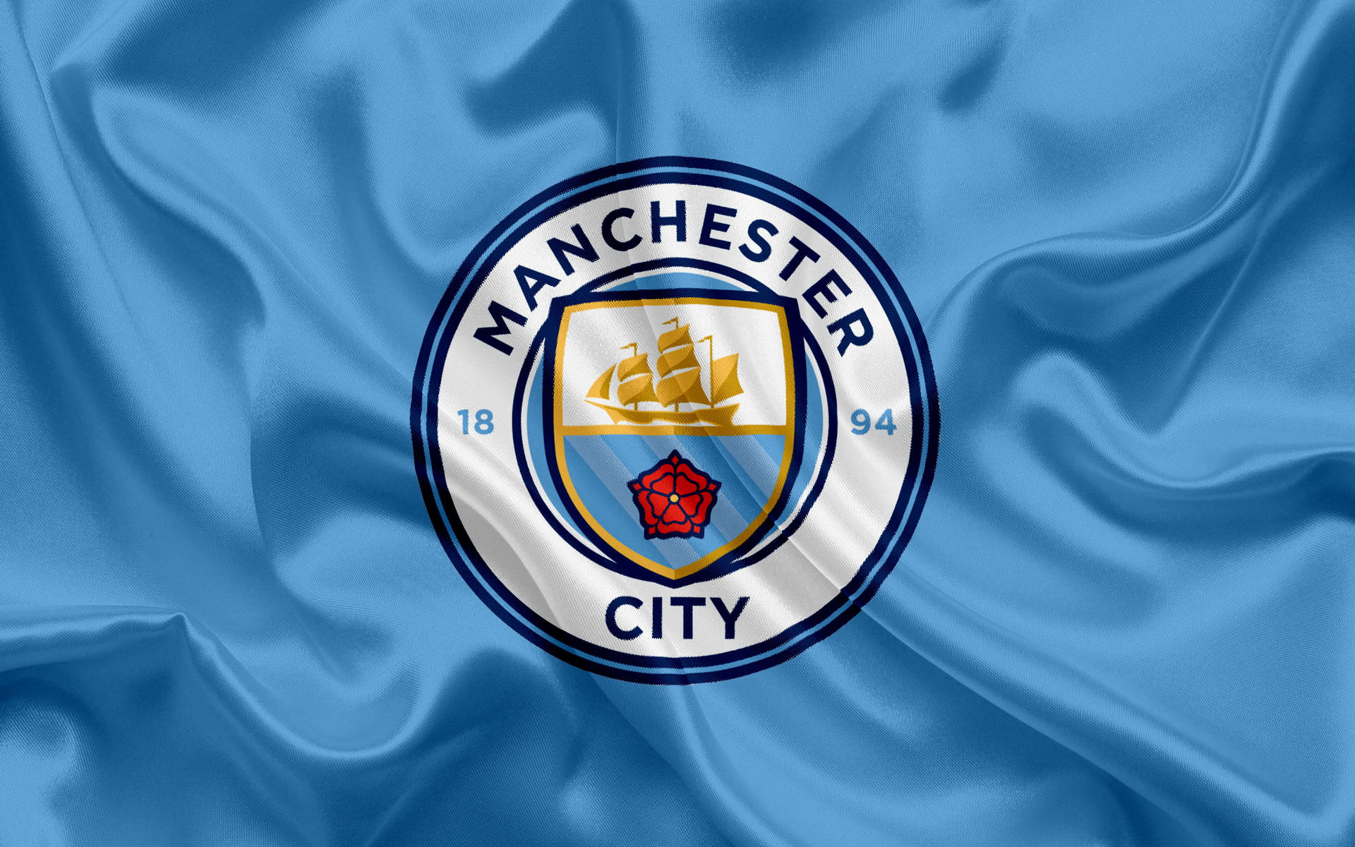 Manchester City Logo On Blue Cloth Background