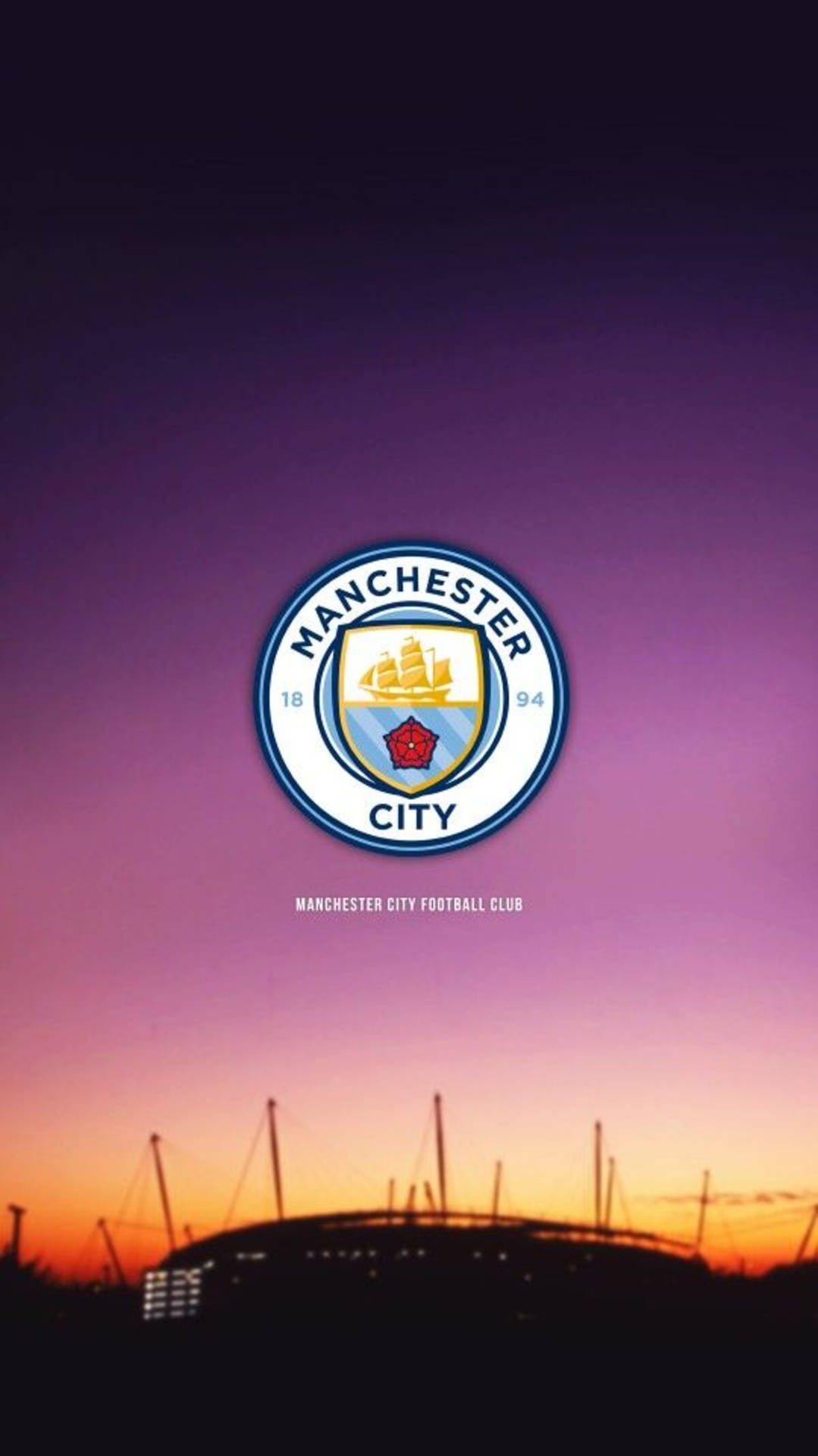 Man City’s Logo Illuminated Against a Magnificent Purple Sky Wallpaper